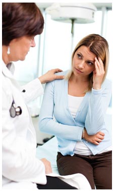 Doctor consoling concerned female patient
