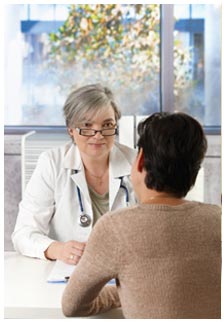 Doctor facing patient, listening to their concerns